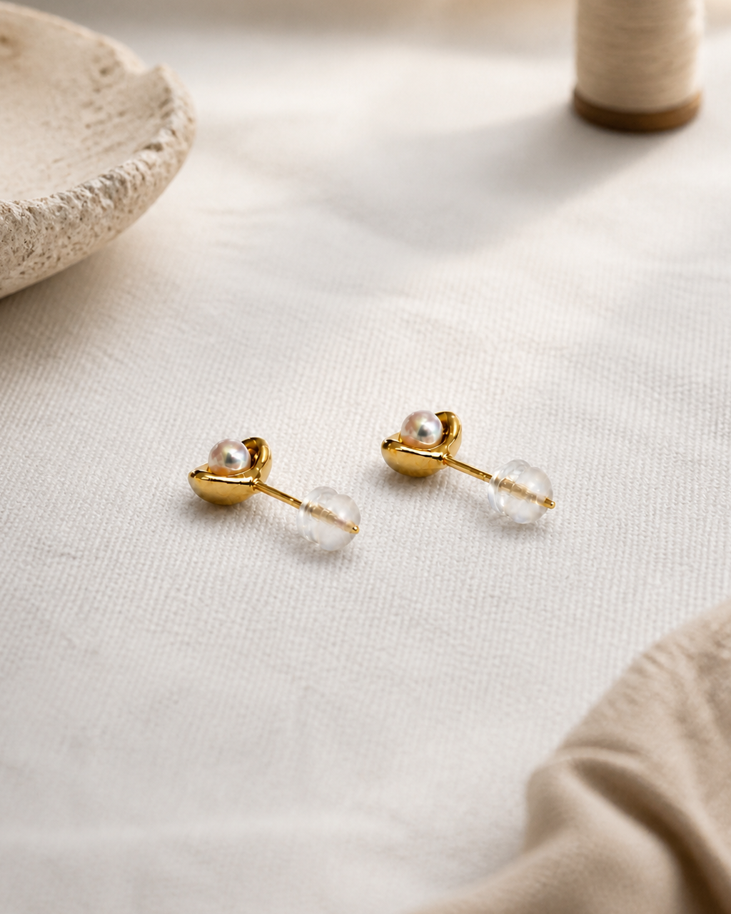 Golden Cradle Petite Pearl Studs — 4:5 styled product photograph