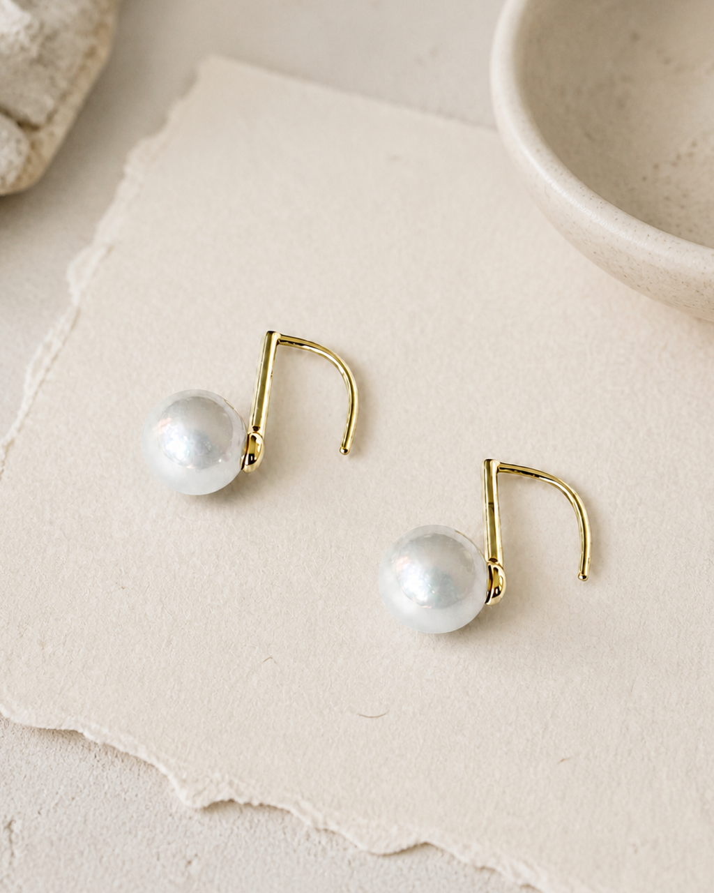 Golden Arc Pearl Drop Earrings — 4:5 styled product photograph