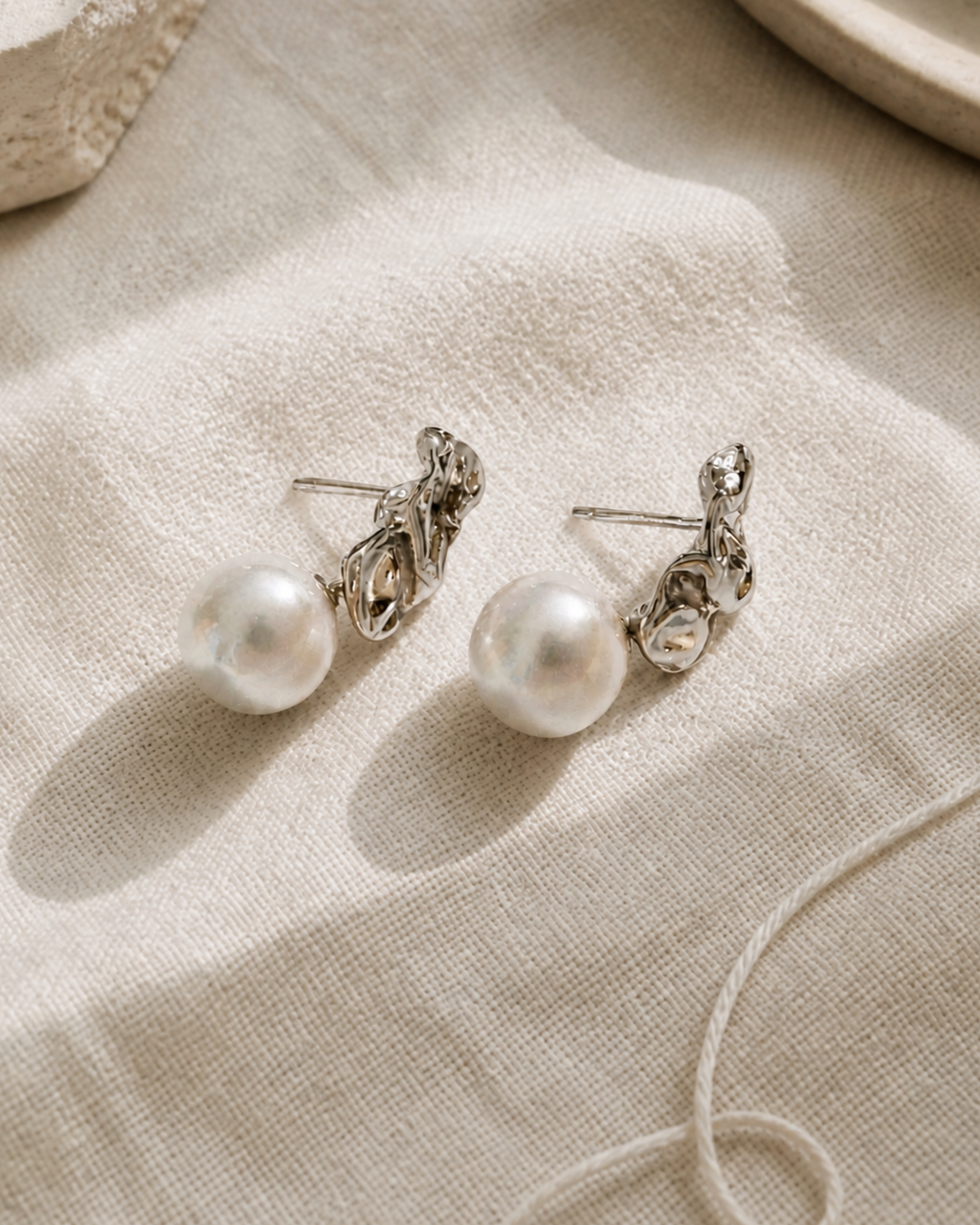 Molten Silver Pearl Drop Studs — 4:5 styled product photograph