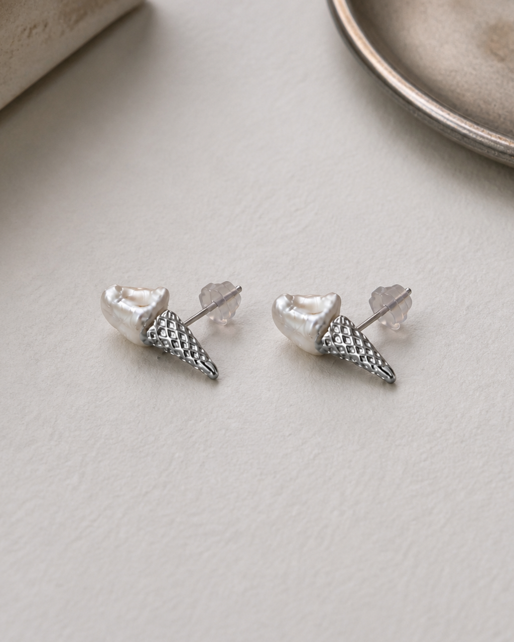 Silver Tidepoint baroque pearl stud earrings — 4:5 styled product photograph