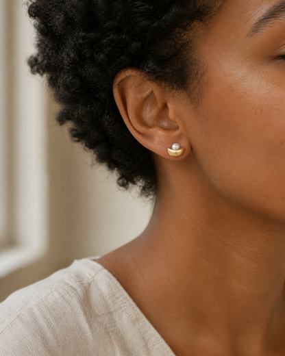 Golden Cradle Petite Pearl Studs — half-moon pearl stud try-on