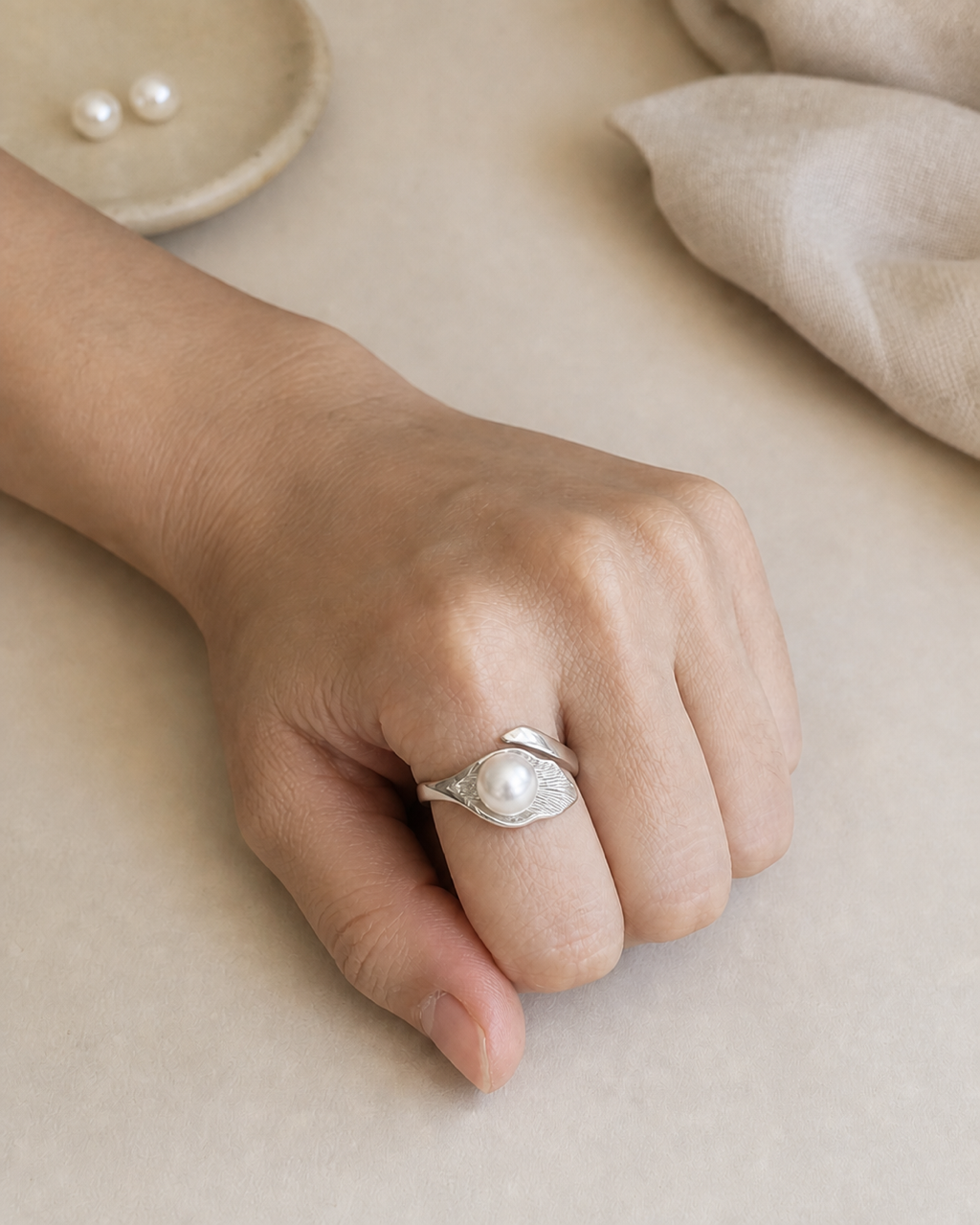 Silver Leaf Pearl Ring worn on the index finger, front-facing try-on