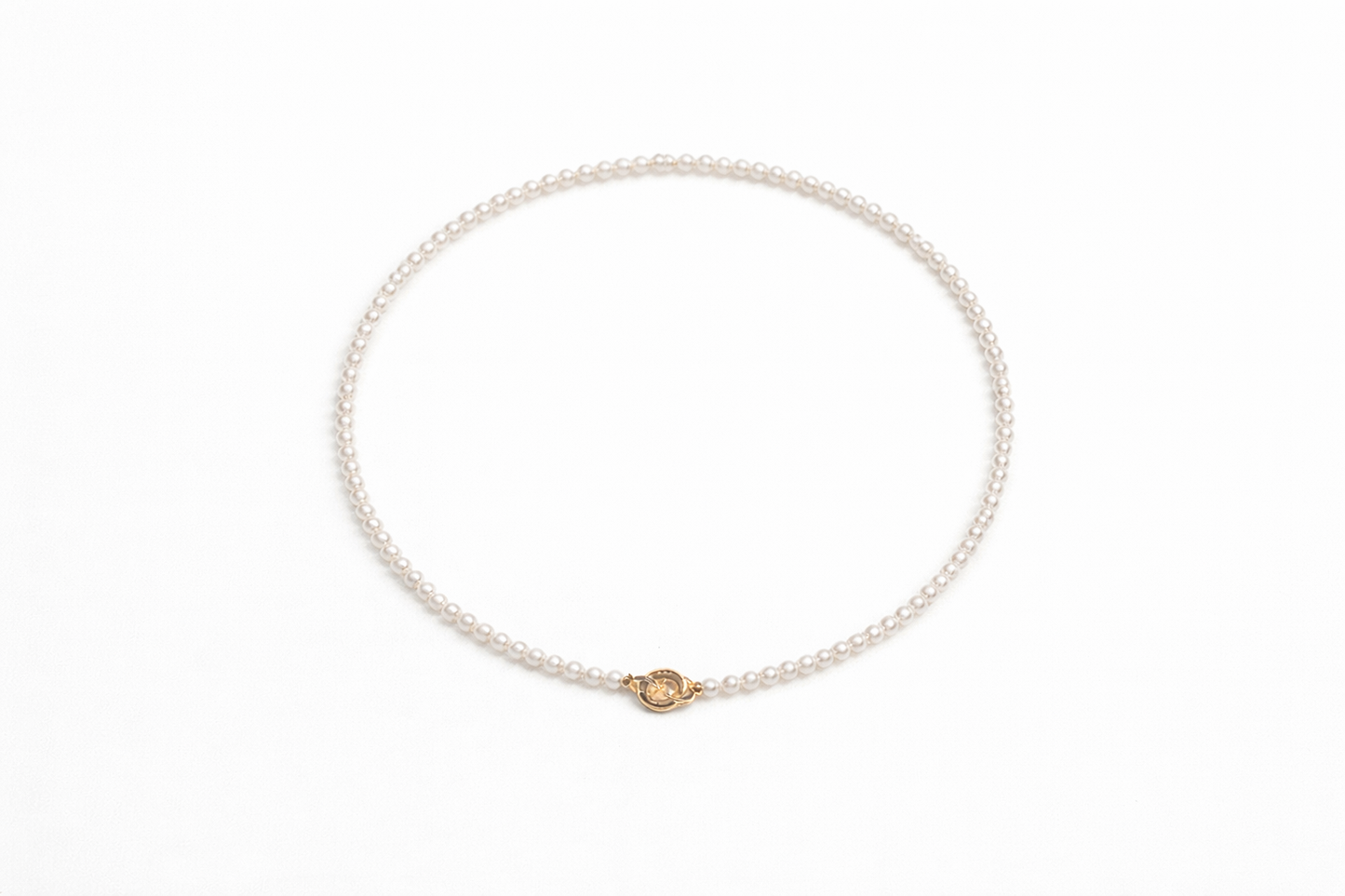 Pearl bracelet with a gold clasp on a white background