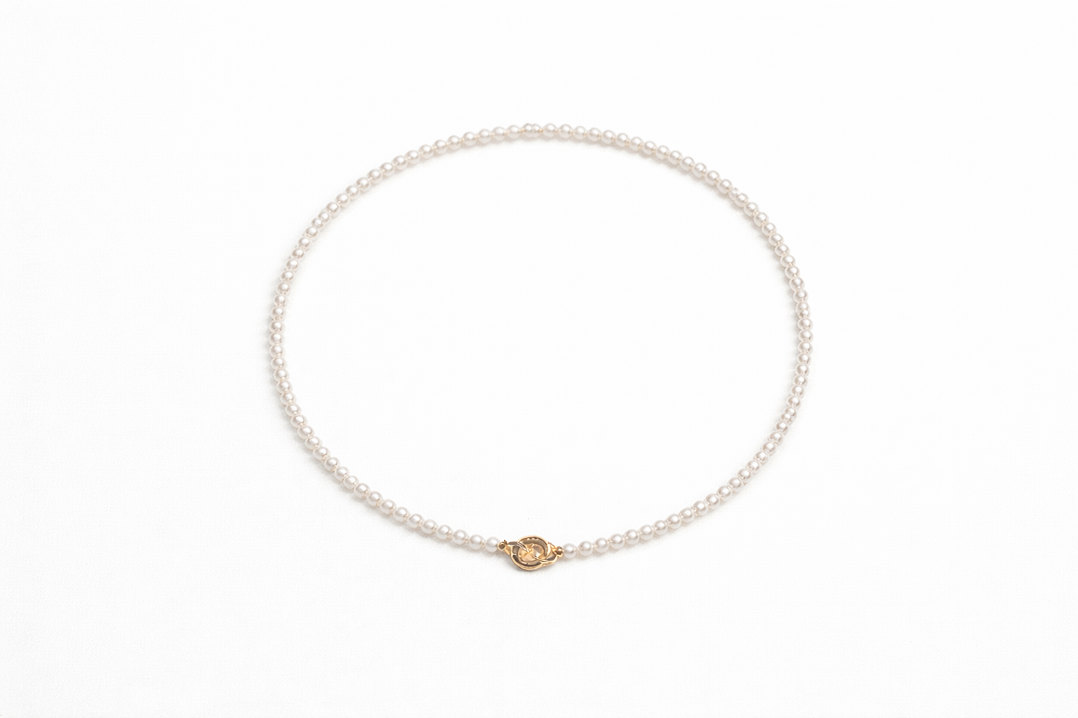 Pearl bracelet with a gold clasp on a white background